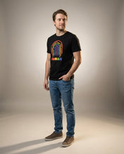 Man wearing the HUMAN Pride tee, full body fashion shot